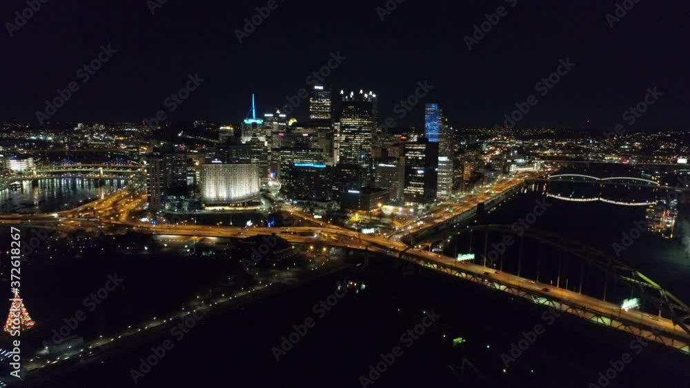 Downtown Pittsburgh Illuminated City Skyline PPG Building at Night Aerial with Water Reflection 4K Downtown Pittsburgh Illuminated City Skyline PPG Building at Night Aerial with Water Reflection 4K