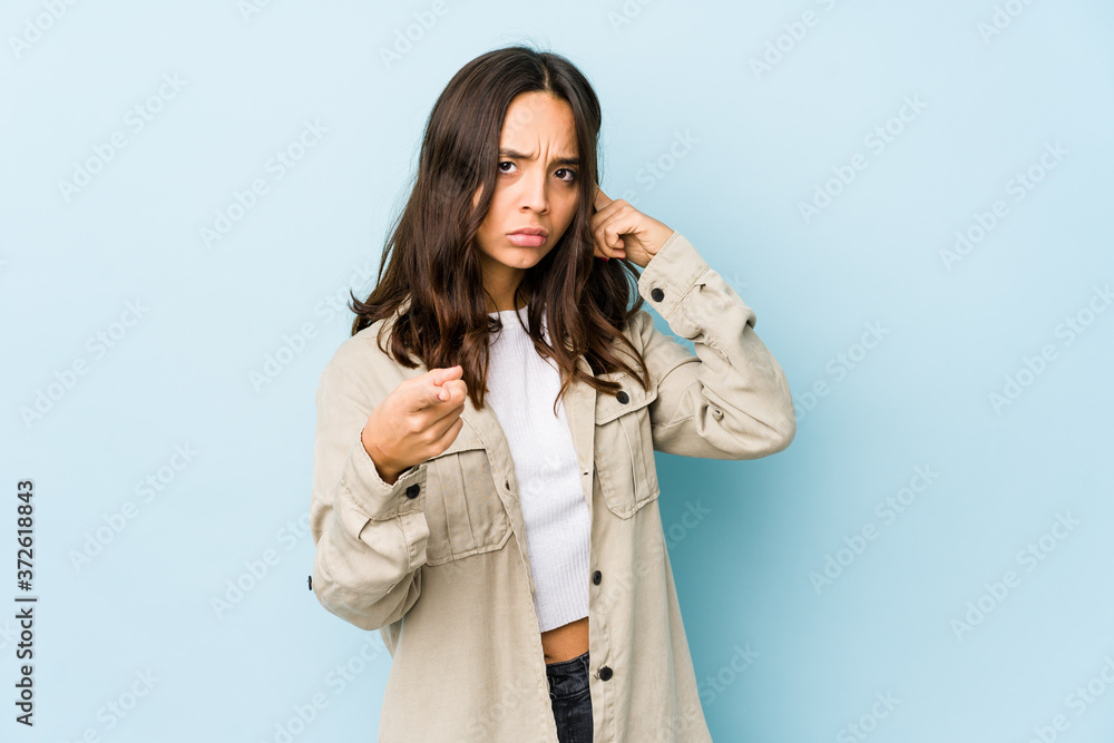 Young mixed race hispanic woman isolated pointing temple with finger, thinking, focused on a task. Young mixed race hispanic woman isolated pointing temple with finger, thinking, focused on a task.