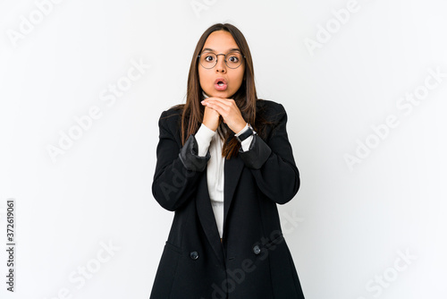 Young mixed race business woman isolated on white background praying for luck, amazed and opening mouth looking to front.