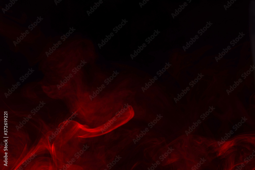 Fototapeta premium Red steam on a black background.