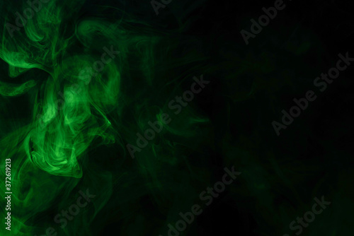 Green steam on a black background. © Nikolay