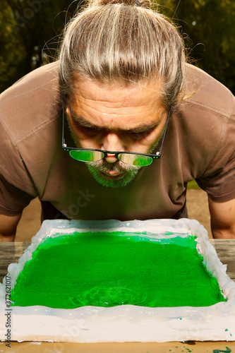 Casting of possible emerald tablet visualisation with epoxy resin to prepared form (no real meaning) photo