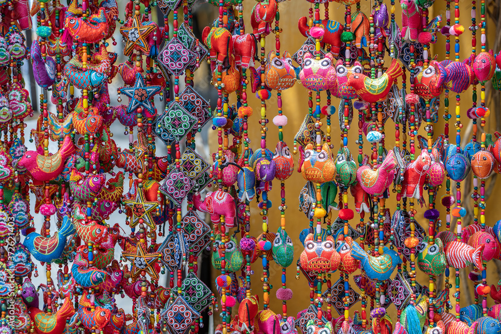Colorful handmade souvenirs for sale in local street market in Hoi An, Vietnam
