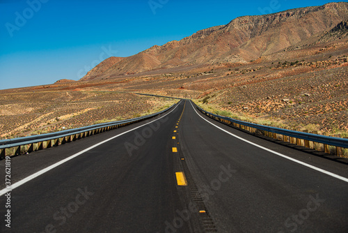 Asphalt texture, way background. Mohave desert by Route 66 in California Yucca Valley USA. American roadtrip.