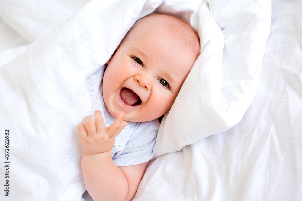 Portrait of a cute baby boy in cotton white after. textiles for the child, hypoallergenic materials. Portrait of a cute baby boy in cotton white after. textiles for the child, hypoallergenic materials.