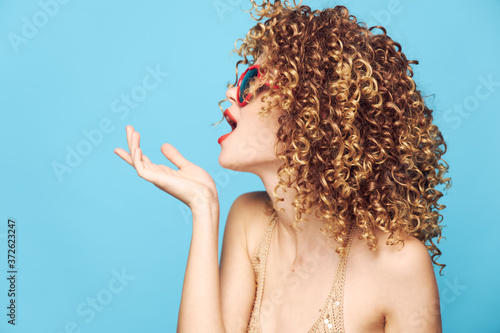 Sweet model expression of feelings on a blue background, red sunglasses 