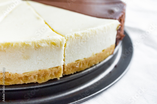 Cheesecake slice, New York style classical cheese cake. Slice of tasty cake on white plate 
