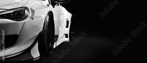 Obraz na plátně Front headlights of modify car on black background,copy space
