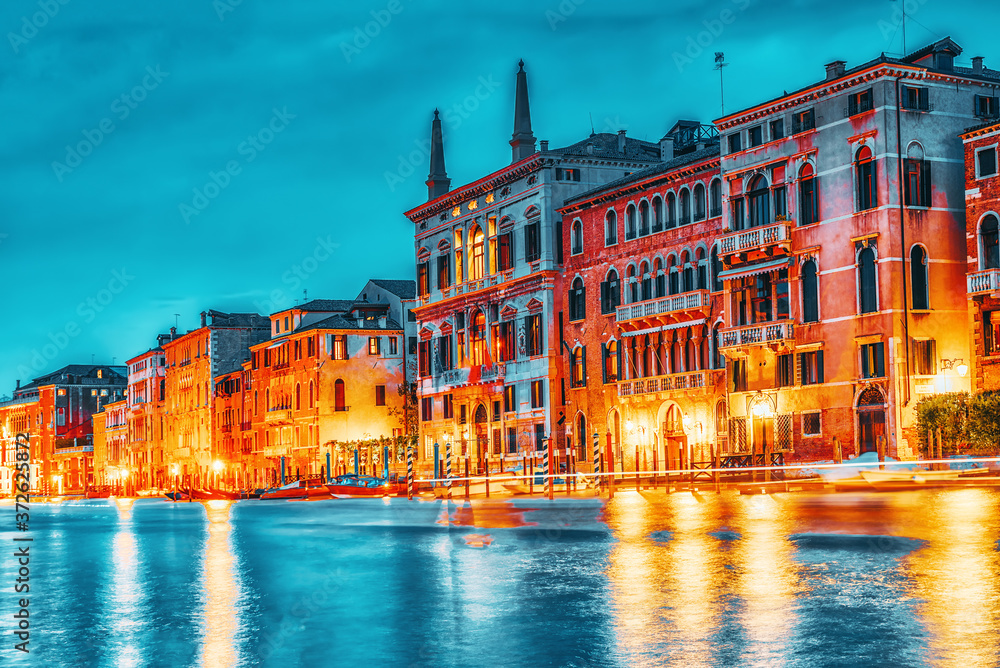 Views of the most beautiful canal of Venice - Grand Canal water streets, boats, gondolas, mansions along. Night view. Italy.