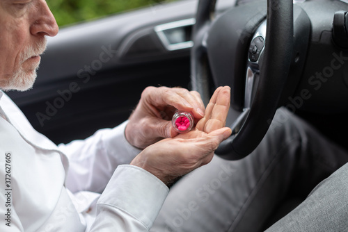Man taking pills before driving