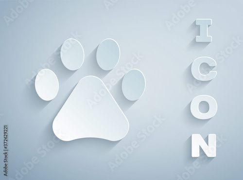 Paper cut Paw print icon isolated on grey background. Dog or cat paw print. Animal track. Paper art style. Vector.