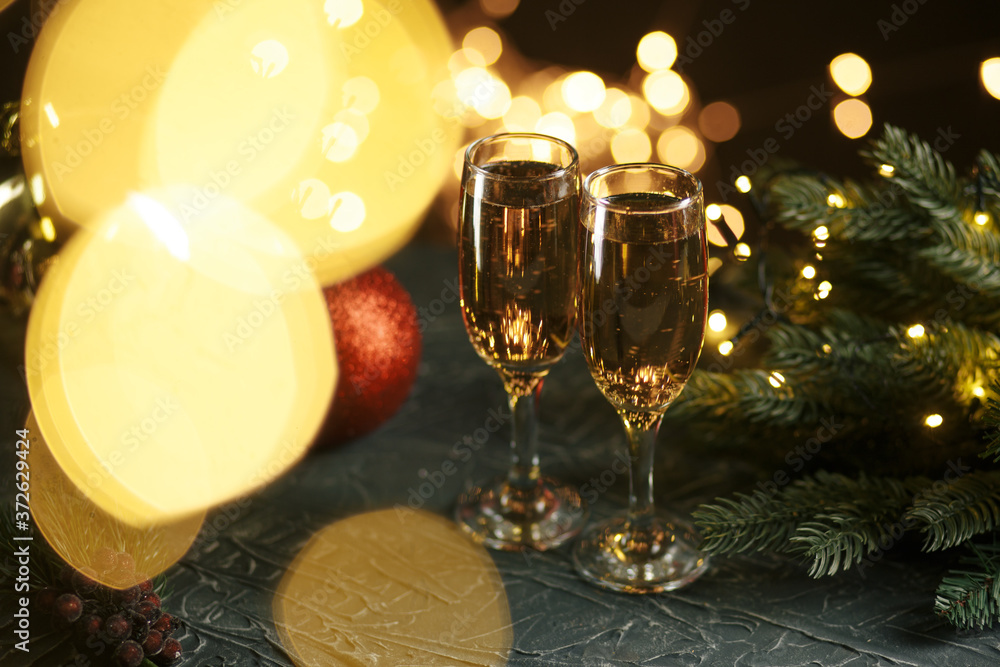 Ribbon, baubles and wine against Christmas lights. Ribbon, baubles and wine against Christmas lights.