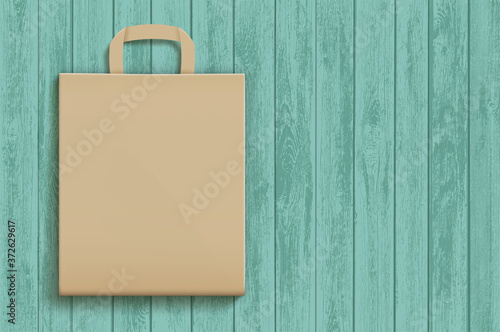 Empty brown paper bag on a wooden surface.