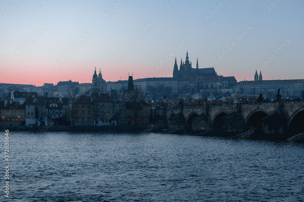 Sunset view of River Vltava, Charles Bridge and Prague Castle in Czech Republic
