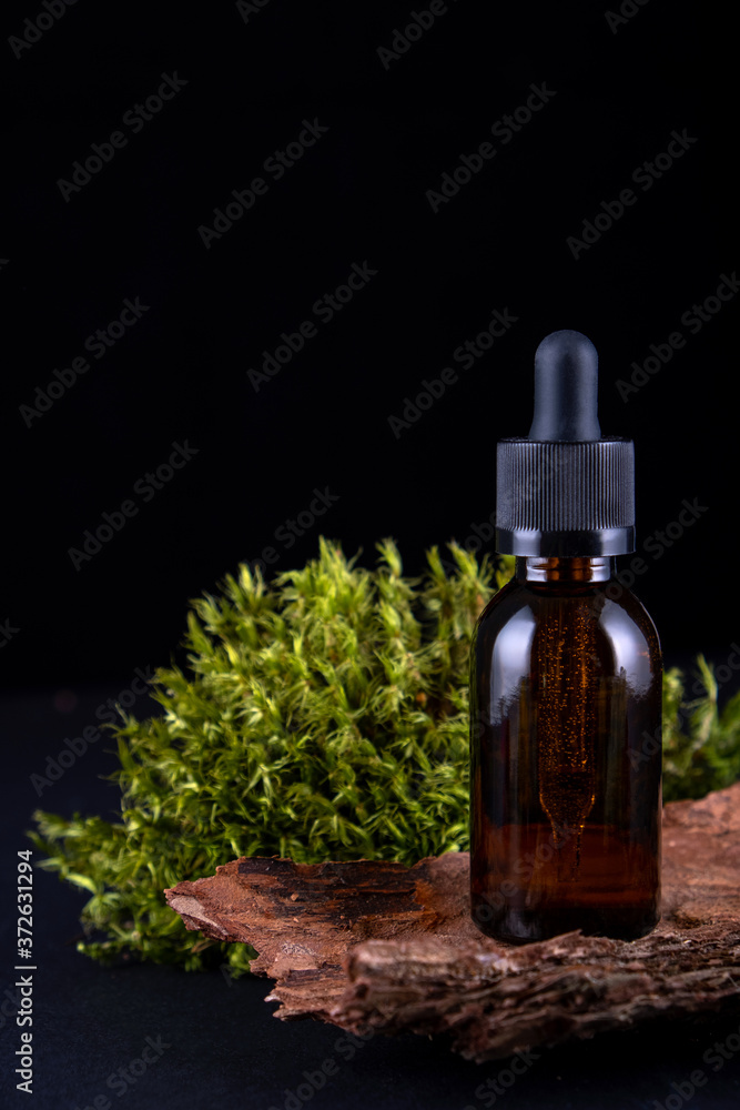 composition with glass bottle of body care organic cosmetics on tree bark pedestal with real , mosses Cosmetic background mock up for product presentation. composition with glass bottle of body care organic cosmetics on tree bark pedestal with real , mosses Cosmetic background mock up for product presentation.