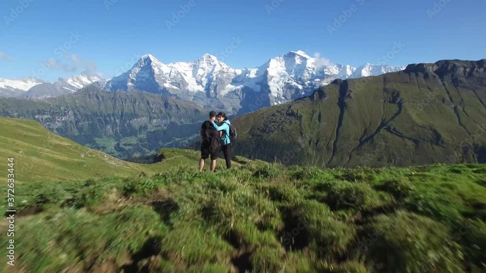 CINEMATIC REVERSE AERIAL OF TOURIST ON SNOW CAPPED MOUNTAIN CINEMATIC REVERSE AERIAL OF TOURIST ON SNOW CAPPED MOUNTAIN