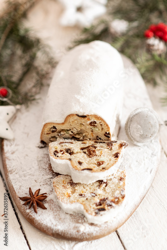 Christmas stollen on wooden background. Traditional Christmas festive pastry dessert. Stollen for Christmas.