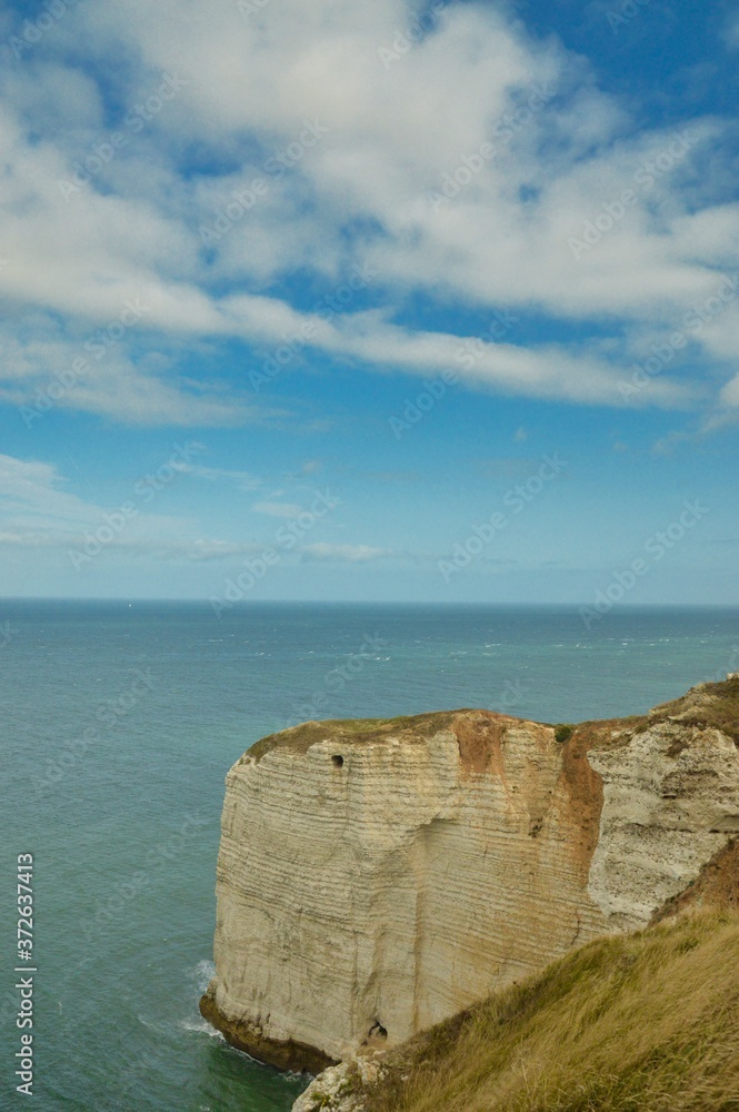 Alabaster coast of Normandie, France with English Channel in background, blue sky