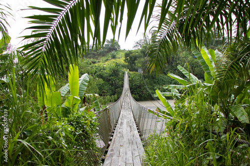 Swinging Bridge above River in Tropical Wilderness - Pampanga, Luzon, Philippines photo