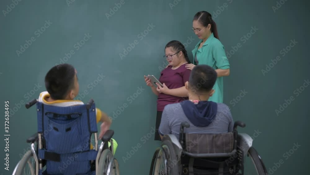 Education concept. Children with disabilities present to their friends in front of the class. 4k Resolution. Education concept. Children with disabilities present to their friends in front of the class. 4k Resolution.
