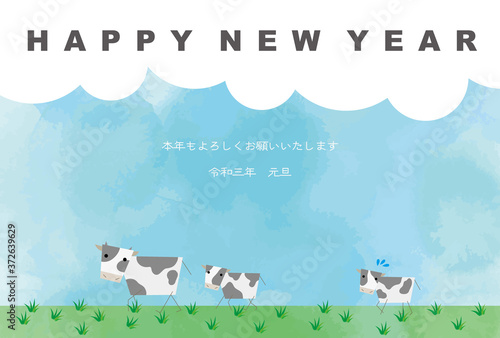 牧草地を歩く牛の親子の年賀状