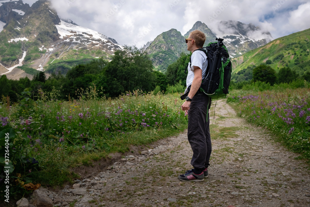 Man with backpack hiking in mountains. Travel Lifestyle success concept