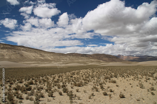View of the mountain and sand dune with dirt road in a sunny day, Tibet, China