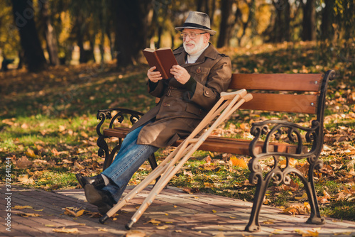 Print op canvas Full length profile side photo of injured old man sit bench crutch enjoy fall fo