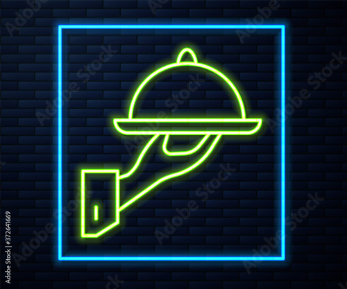 Glowing neon line Covered with a tray of food icon isolated on brick wall background. Tray and lid sign. Restaurant cloche with lid. Vector.