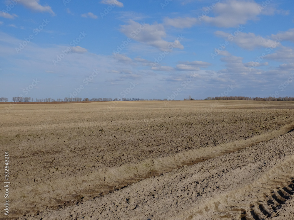 Blue sky over a plowed field. Spring landscape. Agriculture. Blue sky over a plowed field. Spring landscape. Agriculture.