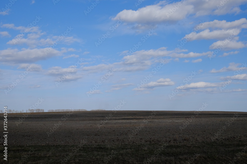 Blue sky over a plowed field. Spring landscape. Agriculture. Blue sky over a plowed field. Spring landscape. Agriculture.