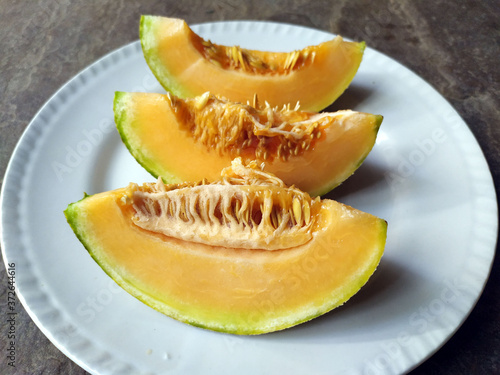 fresh healthy yellow fruit bite put in a white plate