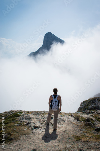 unrecognizable woman looking at a mountain photo