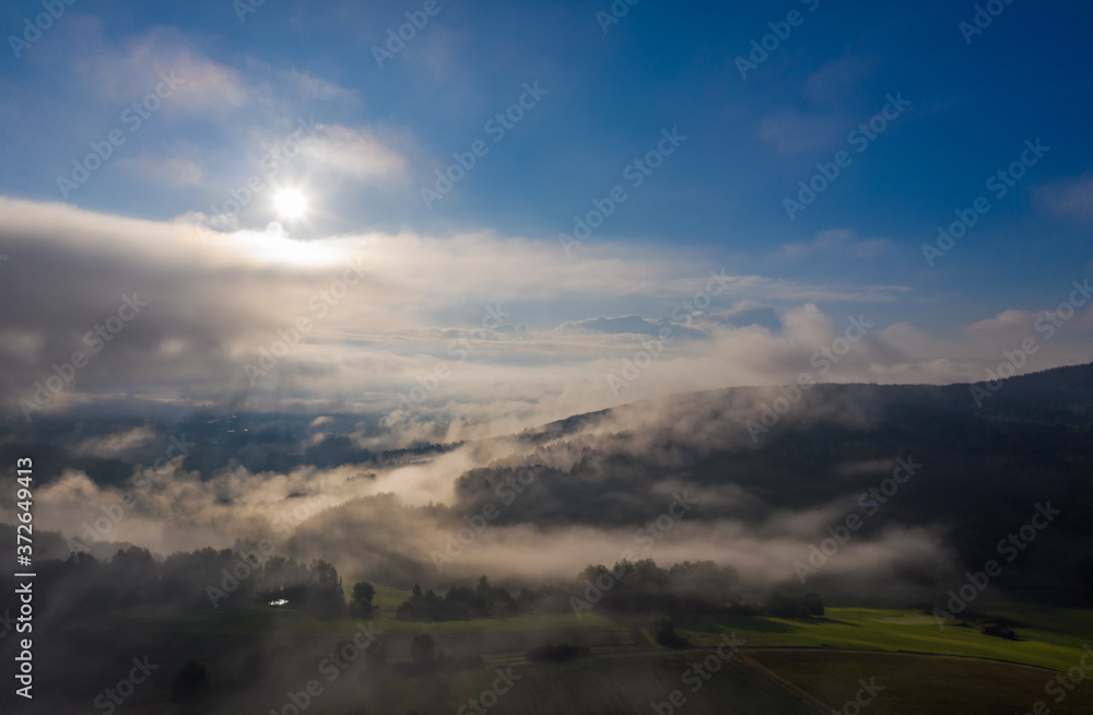sun rise in the Bavarian forest with fog swathes 
