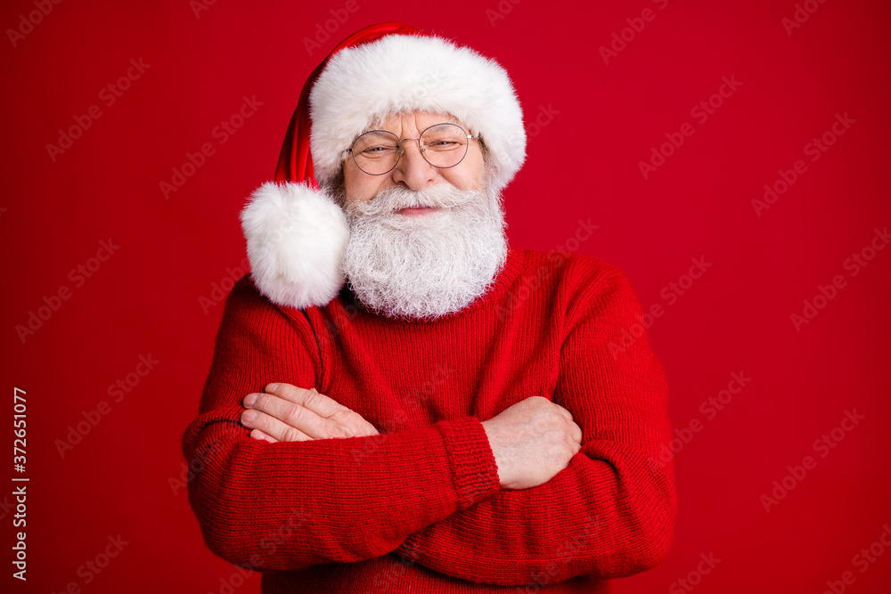 Photo of positive old man in santa claus costume headwear cross hands ready celebrate x-mas magic fairy event wear bright jumper isolated over shine color background