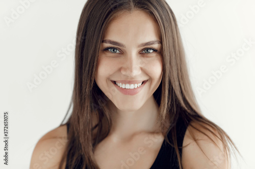Beautiful young woman portrait indoor near white background