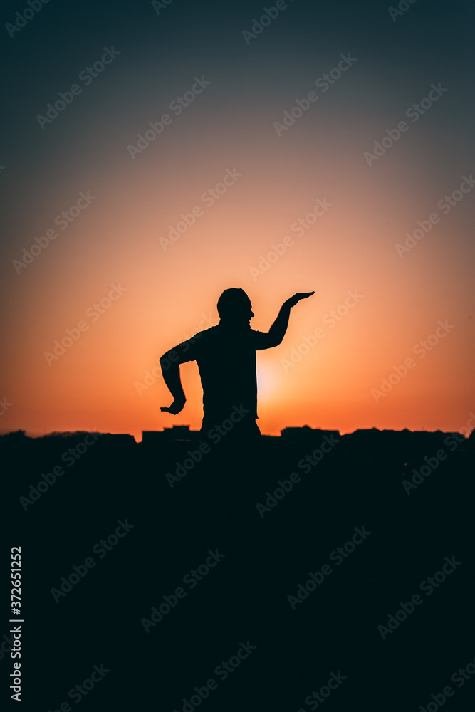 silhouette of a man at sun set 