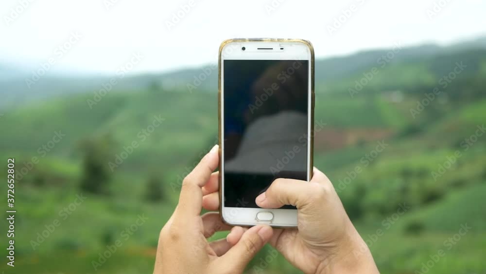 Tourist enjoy nature and take pictures with smartphone on the mountain background. Tourist enjoy nature and take pictures with smartphone on the mountain background.