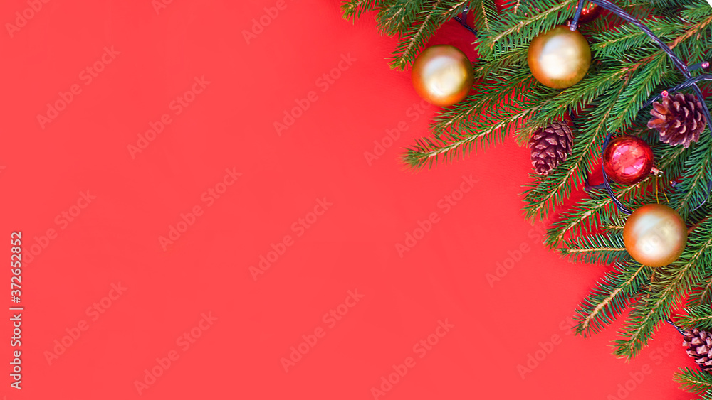 Christmas background with xmas tree on red canvas background. Merry christmas card. Winter holiday theme. Happy New Year. Space for text. christmas backdrop top view. Flat lay.