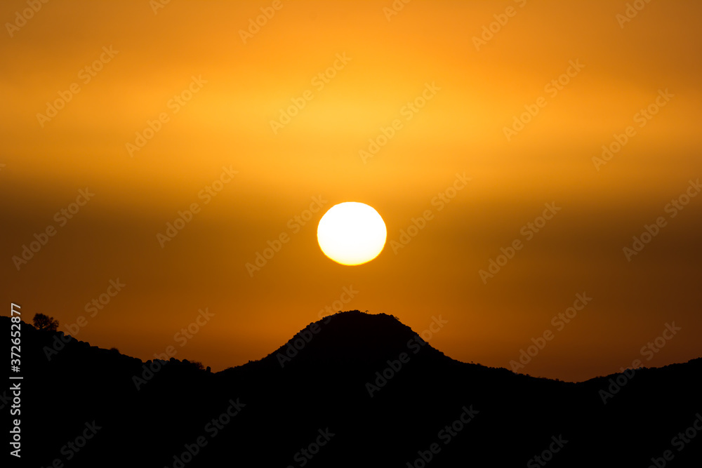 Fototapeta premium African sunset behind hill silhouette
