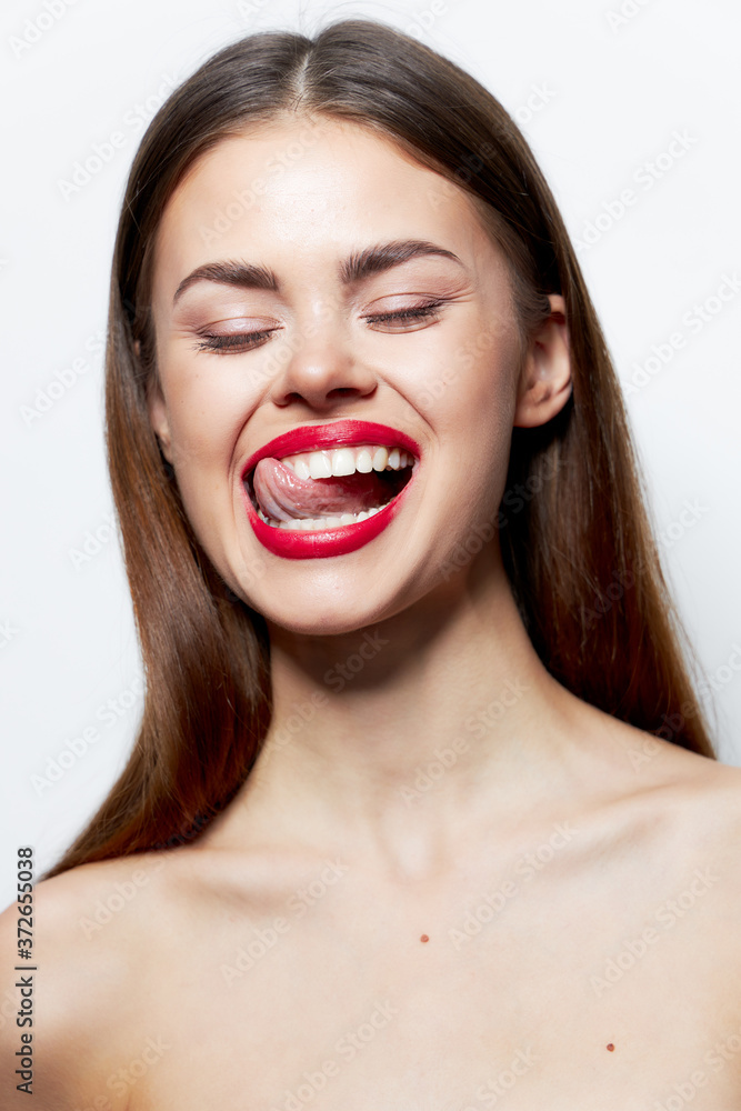 Charming woman bare shoulders With closed eyes, clear skin shows the tongue Charming woman bare shoulders With closed eyes, clear skin shows the tongue