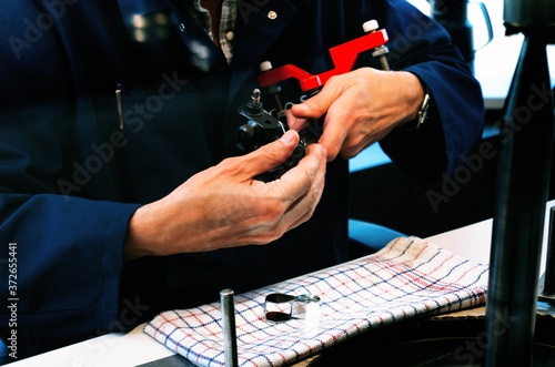 Amsterdam, Netherlands - July 2019: A skilled worker are shaping diamond they at the factory in Amsterdam, Netherlands. photo