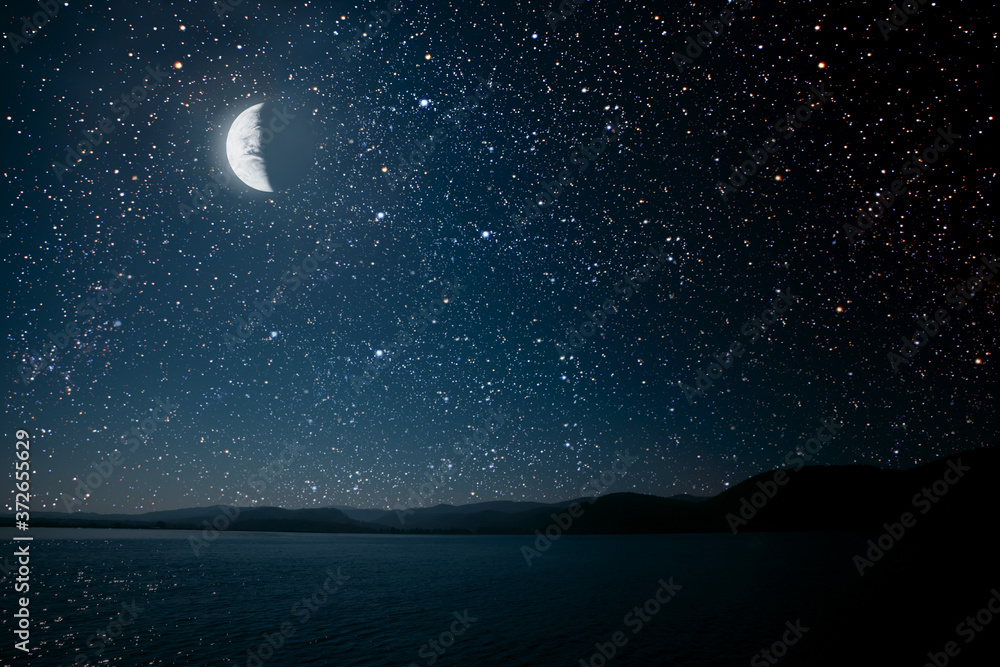 moon against a bright night starry sky reflected in the sea. moon against a bright night starry sky reflected in the sea.