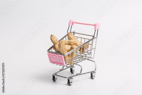 Peanut fruit and shopping cart on white background
