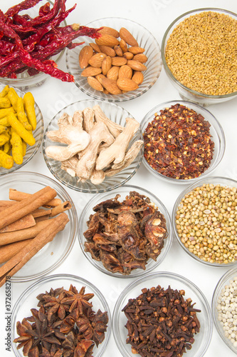 Aromatic spices on wooden spoons. Food ingradients.

