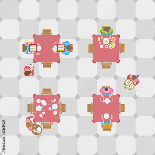 People at the tables in the cafe and the waiters. Top view. A restaurant. View from above.