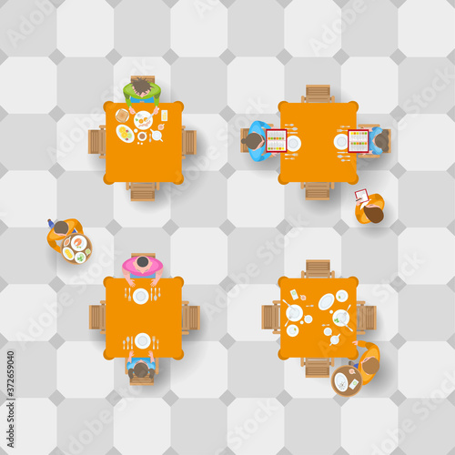 People at the tables in the cafe and the waiters. Top view. A restaurant. View from above.