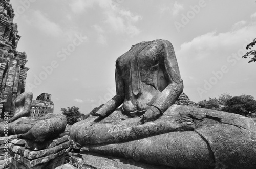 Black and white image of headless buddha images in Thai temple photo