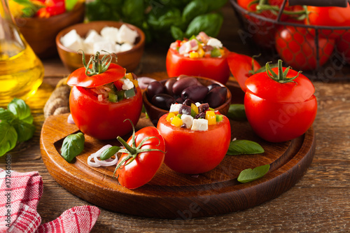 Greek stuffed tomato with feta cheese, olives, and fresh pepper.