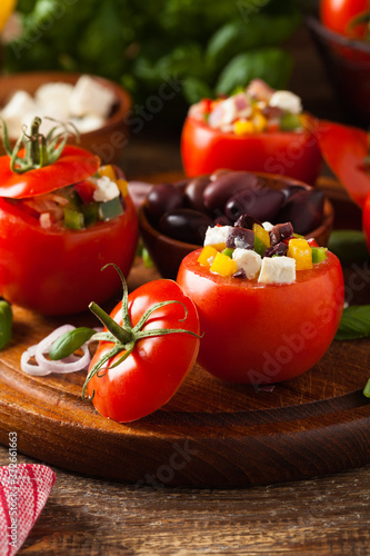 Greek stuffed tomato with feta cheese, olives, and fresh pepper.